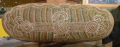 Australian aboriginal softwood coolamon with acrylic paint design.